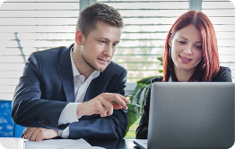 Images displays two employees looking at an employee portal