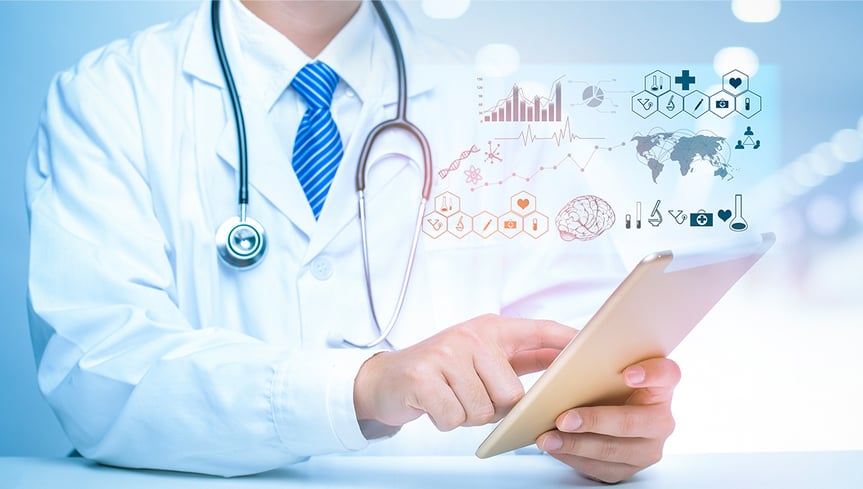Photo of doctors’ hands pointing to schematics of a human brain on a laptop screen. 